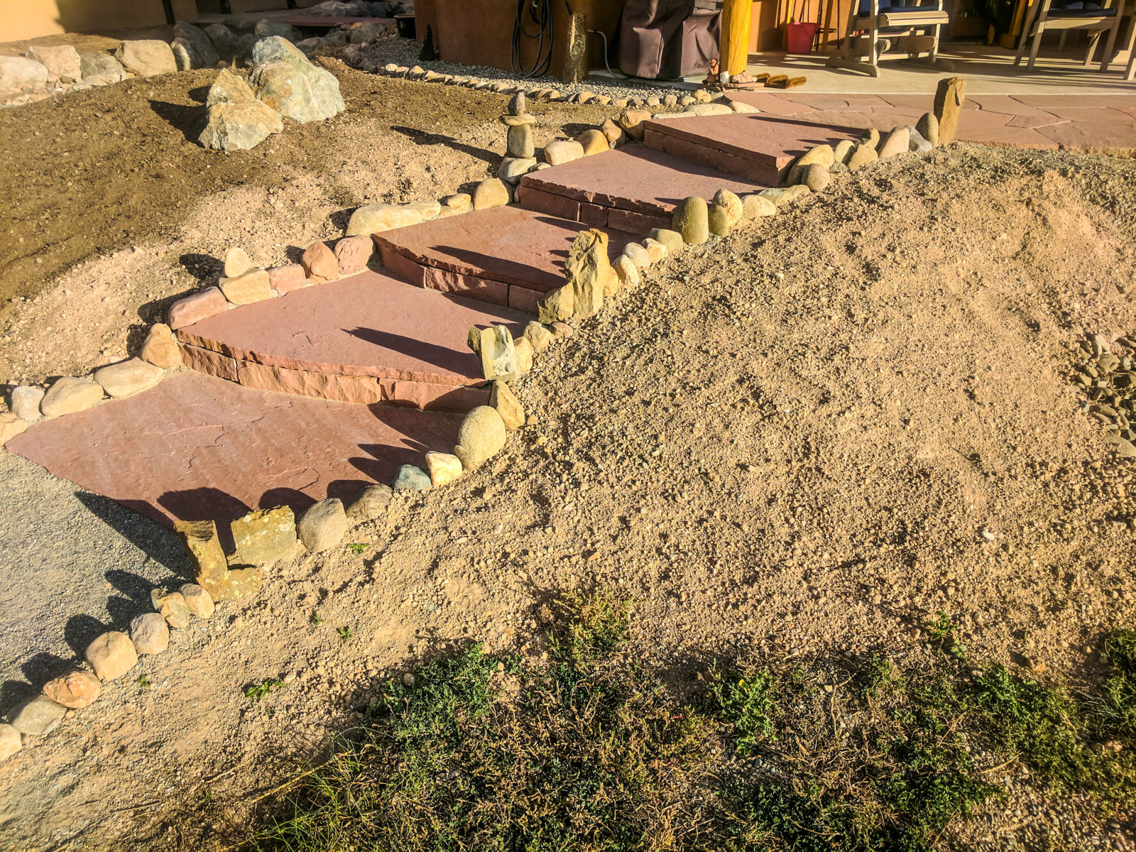 Stone steps leading up to the client's patio in this landscape design Dan created for his client